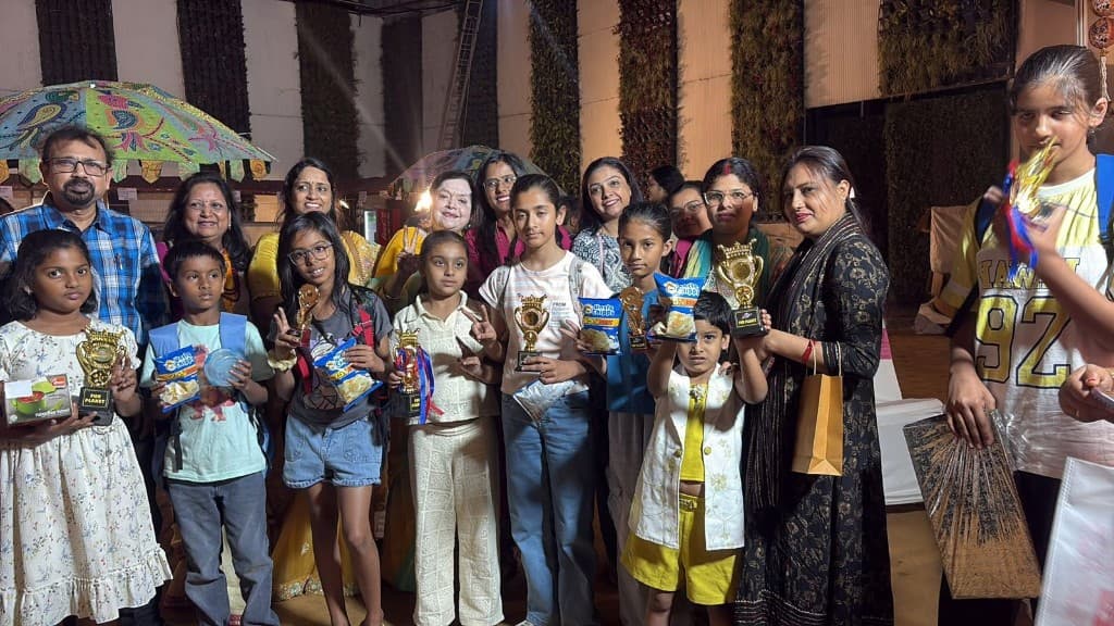 Parents and children celebrating with trophies at Funplanet annual day