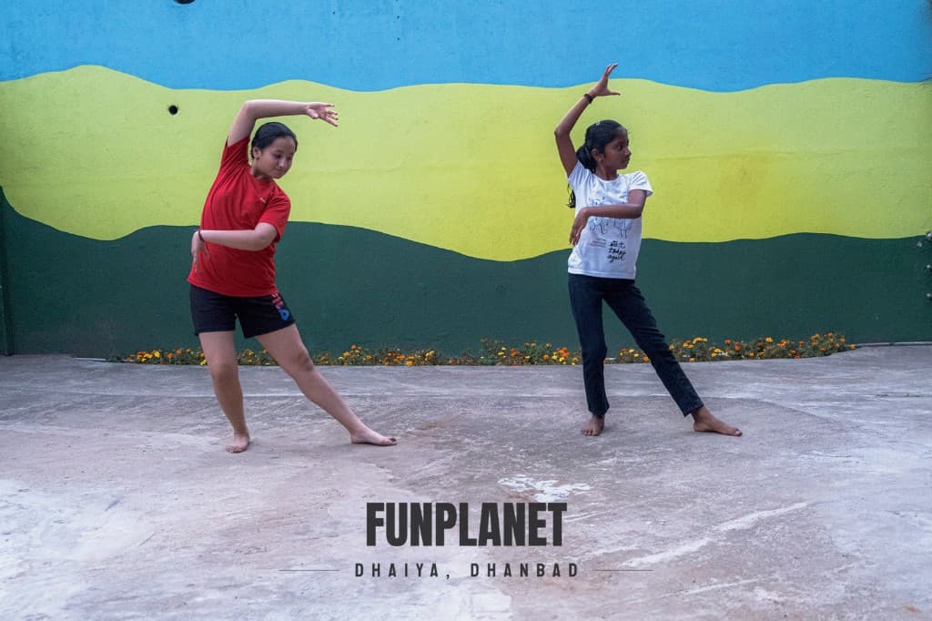 Students practicing dance moves in the outdoor Funplanet studio